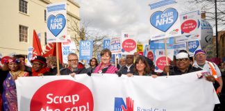 Nurses marching to defend the NHS demanding the 1% pay cap be scrapped