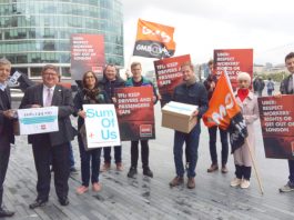 ‘Force Uber to respect workers’ rights or get out of London!’–GMB hands 100,000 petition to City Hall London Assembly member UNMESH DESAI (left) receives the over 100,000-strong petition from GMB official STEVE GARELICK outside City Hall on Monday morning