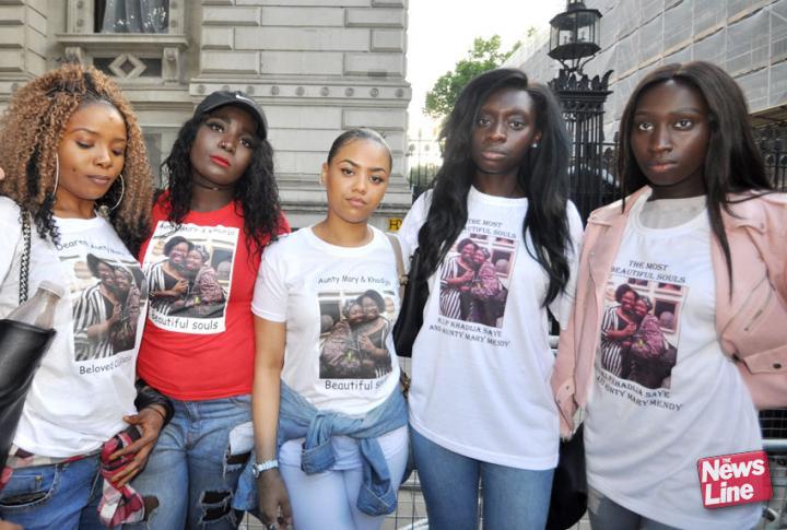 Cousins of Kadija Saye and her mother Mary Mendy, who both died in the Grenfell Tower inferno, on a march to Downing Street