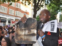 At a march demanding Justice for Grenfell a local resident holds a piece of the cladding which contributed to the deaths in North Kensington