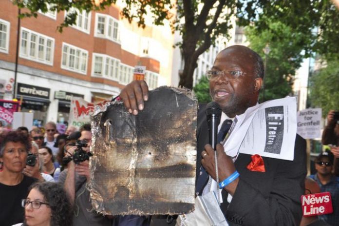 At a march demanding Justice for Grenfell a local resident holds a piece of the cladding which contributed to the deaths in North Kensington