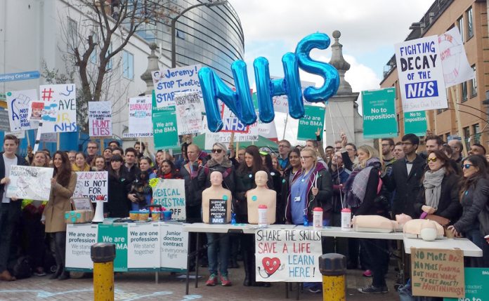 Junior doctors and supporters of their strike outside King’s College Hospital in south London in 2016 – the Trust’s head has quit over cuts