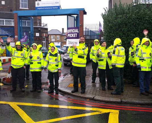 Deptford ambulance workers on the picket line during their nationwide strike in 2014 – they are overworked, understaffed and underpaid