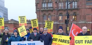 Train staff joined forces with furious commuters demonstrating at stations across the country against massive rail fare hikes which came in yesterday morning – MICK CASH (centre) RMT General Secretary, who joined the King’s Cross protest, called for the c