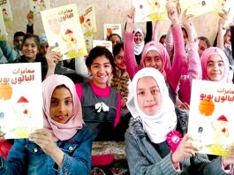 Young Iraqi girls hold copies of ‘The Adventures of Booboo the Balloon’. They are now writing their own stories