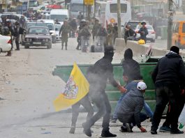 Palestinian youth clash with Israeli forces at the Qalandia checkpoint outside Ramallah