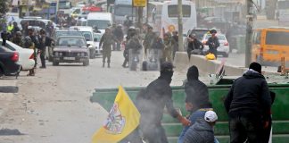 Palestinian youth clash with Israeli forces at the Qalandia checkpoint outside Ramallah