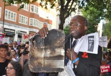 Grenfell resident holds up a piece of charred cladding which had fallen during the Grenfell Tower inferno