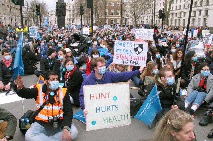 Junior doctors block Whitehall during their strike – doctors oppose NHS England’s new dangerous ‘Stay Well Pharmacy’ campaign