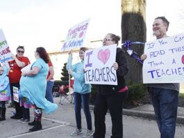 Raleigh County teachers and supporters picket at Shoemaker Square in Beckley during the first day of the statewide teachers’ walk-out