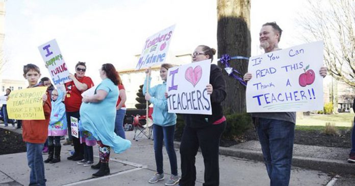 Raleigh County teachers and supporters picket at Shoemaker Square in Beckley during the first day of the statewide teachers’ walk-out