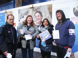 Striking university lecturers on the picket line at Imperial College are presented with a box of biscuits by a supporter