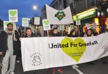 The front of the Silent March for Grenfell making its way down Kensington High Street