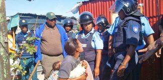 A South African woman is forcibly evicted from her home after the Marikana massacre