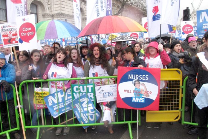 Nurses rally outside Downing Street demanding an end to cuts and for kicking privateers out of the NHS