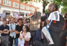 Resident of North Kensington holds a piece of the charred cladding from the Grenfell Tower inferno – building materials will still not be rigorously tested to see if they are flammable as the Tories have refused to rule out ‘desktop assessments’