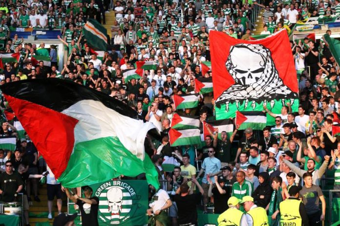 Fans of Scottish team Celtic raise Palestinian flags during a game against Israeli team Hapoel Beersheba last year