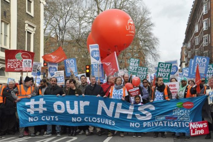 Health workers marching to defend the NHS, demanding no cuts, no closures and no privatisation
