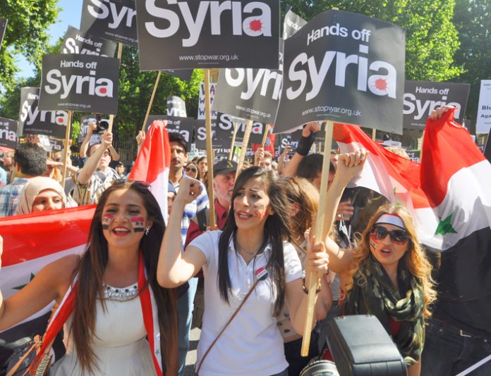 Hands off Syria’ demonstration in London in 2013 when former PM Cameron’s vote for bombing was defeated in Parliament – PM May has bypassed Parliament to authorise military action