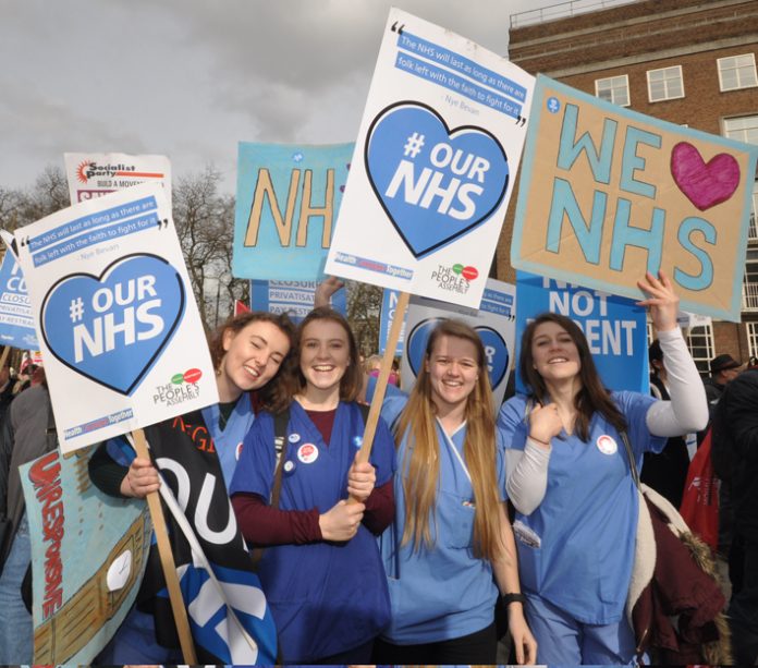 Nurses on the ‘Our NHS’ demonstration in central London – in Manchester health and council workers are striking against the merger of their services