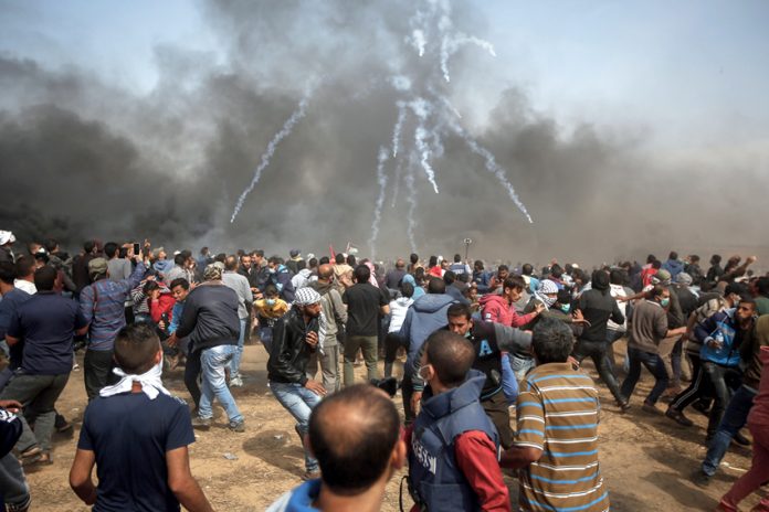 Palestinians on the Great March of Return on the Gaza border on Friday defy Israeli army snipers and hails of teargas