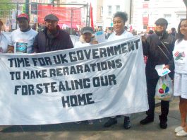 May Day Marchers Demand ‘Kick The Tories Out!’ Chagos Islanders with their banner demanding reparations from the government for the stealing of their homeland