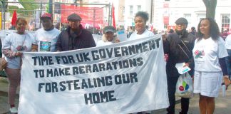 Chagos Islanders with their banner demanding reparations from the government for the stealing of their homeland