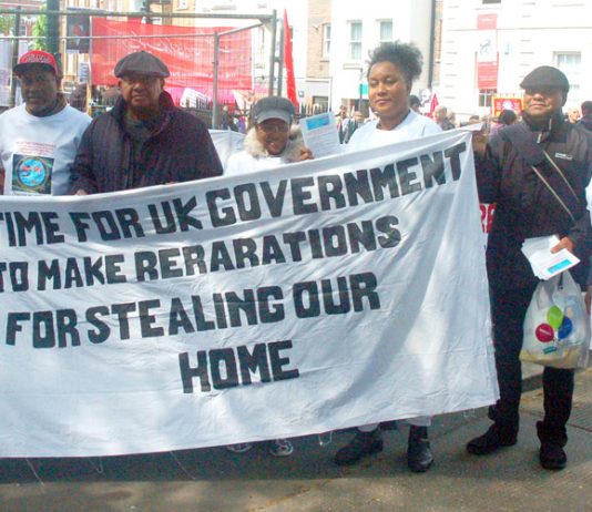 Chagos Islanders with their banner demanding reparations from the government for the stealing of their homeland