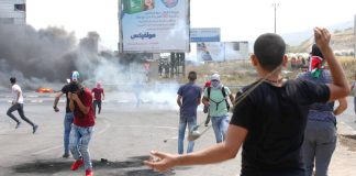 Palestinian youth clash with occupation forces at the Hawara checkpoint, south of Nablus city