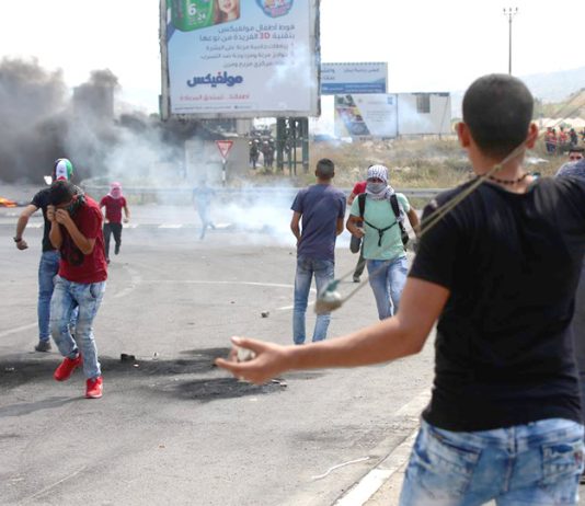 Palestinian youth clash with occupation forces at the Hawara checkpoint, south of Nablus city