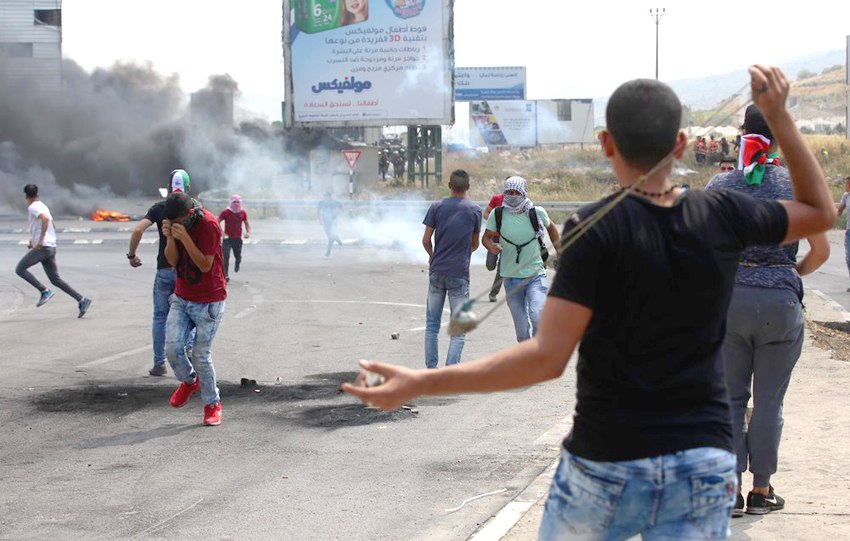 Palestinian youth clash with occupation forces at the Hawara checkpoint, south of Nablus city