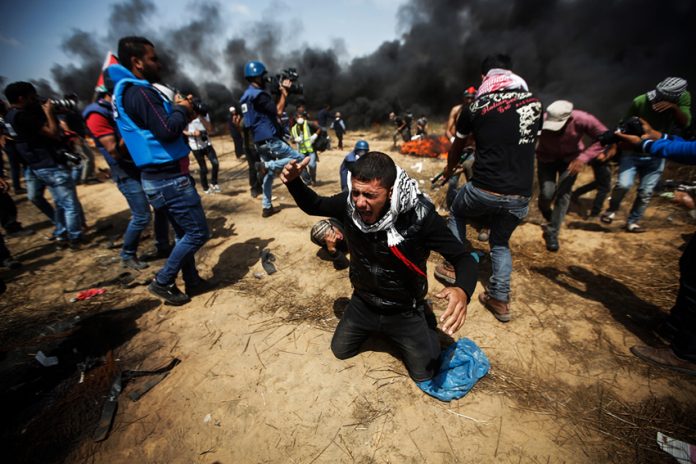 Palestinians close to the Gaza-Israel border fence. Over 100 have been killed since Land Day March 30