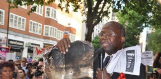 North Kensington resident holds up charred insulation from the Grenfell Tower inferno – cladding used on the tower has been revealed to be more flammable than petrol