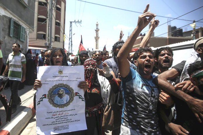 Palestinians on the funeral march of Palestinian paramedic Razan Ashraf al-Najjar killed by Israeli forces on the Gaza-Israel border