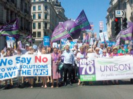 Unison members on the NHS 70th anniversary demonstration in London with (left) strikers from the Wrightington, Wigan & Leigh hospital over plans to transfer their jobs to a private company