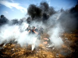 Palestinians demonstrating on the Gaza border with Israel under attack from Israeli armed forces
