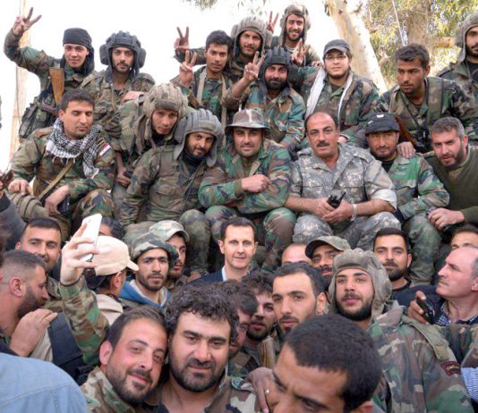 Syrian President BASHAR AL-ASSAD surrounded by Syrian troops during the liberation of Ghouta