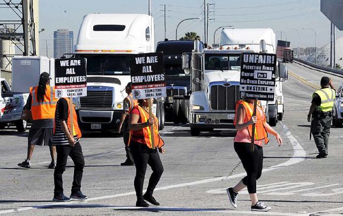 Teamster union port workers demonstrating against ‘misclassification’ – the New Jersey Attorney General has lodged a complaint against ‘misclassification’