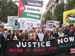 ‘Labour Must Stick To Its Guns In Championing Palestinian Rights For Freedom And Justice!’ Palestinian Ambassador MANUEL HASSASSIAN (centre, in cap) on a march in London last November to condemn the Balfour Declaration