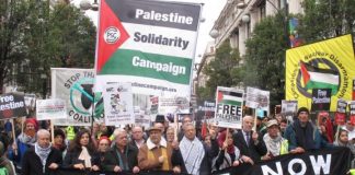 Palestinian Ambassador MANUEL HASSASSIAN (centre, in cap) on a march in London last November to condemn the Balfour Declaration