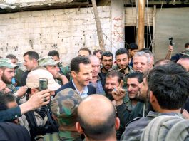 Syrian President BASHAR AL-ASSAD greets troops after the liberation of Ghouta province