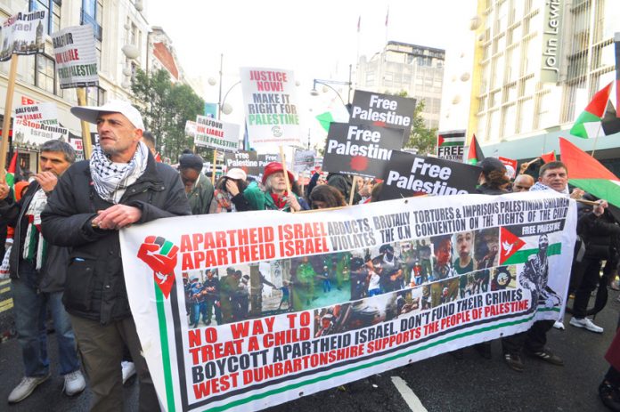Banner on the ‘Justice Now’ demonstration in London earlier this year demanding a boycott of Israel
