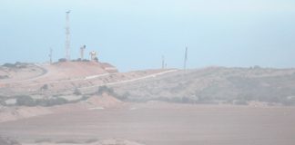 Palestinians on the Great March of Return on the Gaza border with Israel protest under the shadow of Israeli military observation posts and spy towers – farmers have now been fired on from these posts