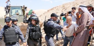 Israeli military bulldozer razing Palestinian farmland