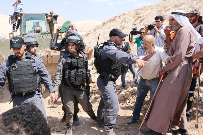 Israeli military bulldozer razing Palestinian farmland