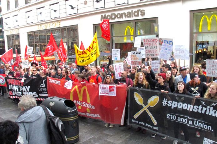 Fast food workers rallying outside McDonald’s in Leicester Square, central London yesterday demanded ‘Fair Pay Now!’
