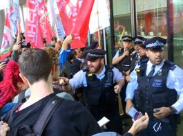 Police outside the Uber HQ desperate to stop Uber drivers and their supporters from entering the building