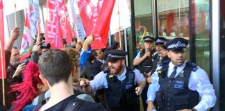 Police outside the Uber HQ desperate to stop Uber drivers and their supporters from entering the building