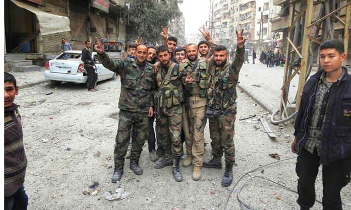 Syrian troops celebrate a victory against terrorist forces