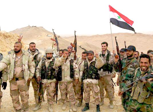 Syrian troops celebrate a victory over terrorists in the north of Syria